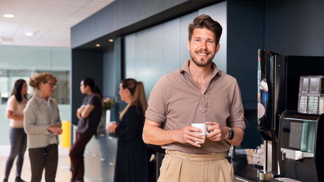 Smiling Man Getting Coffee