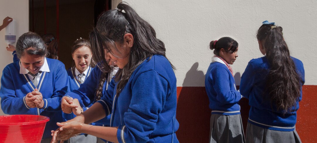 Schoolgirls washing hands between classes.