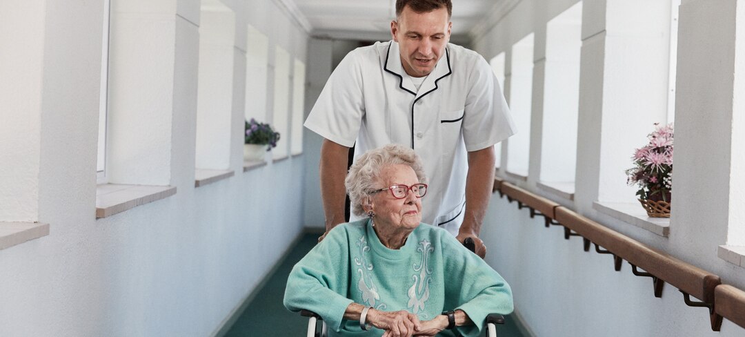 FemaleElderlyWithCaretakerUsingWheelchair-2880x1300.jpg